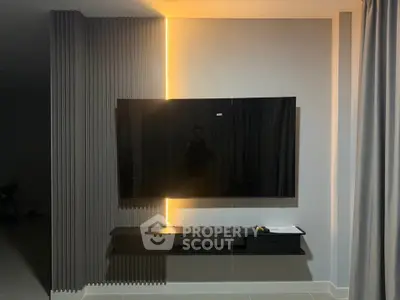 Modern living room with sleek TV setup and ambient lighting