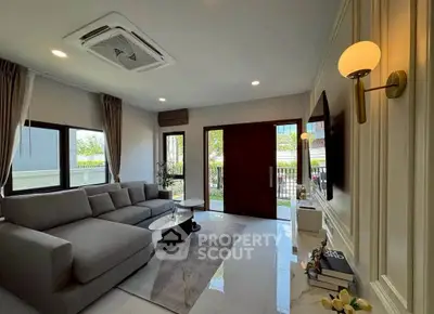 Spacious modern living room with elegant decor and large windows for natural light.