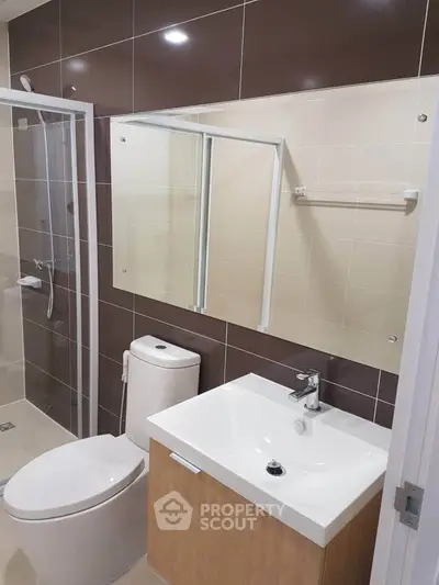 Modern bathroom with sleek fixtures and glass shower enclosure