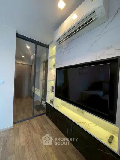 Modern living room with sleek TV setup and elegant wood flooring