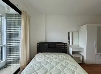 Cozy bedroom with natural light and modern furnishings, perfect for restful nights.