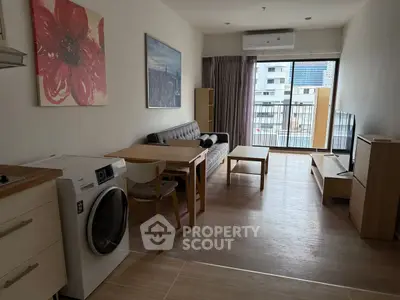 Modern living room with washing machine and balcony view