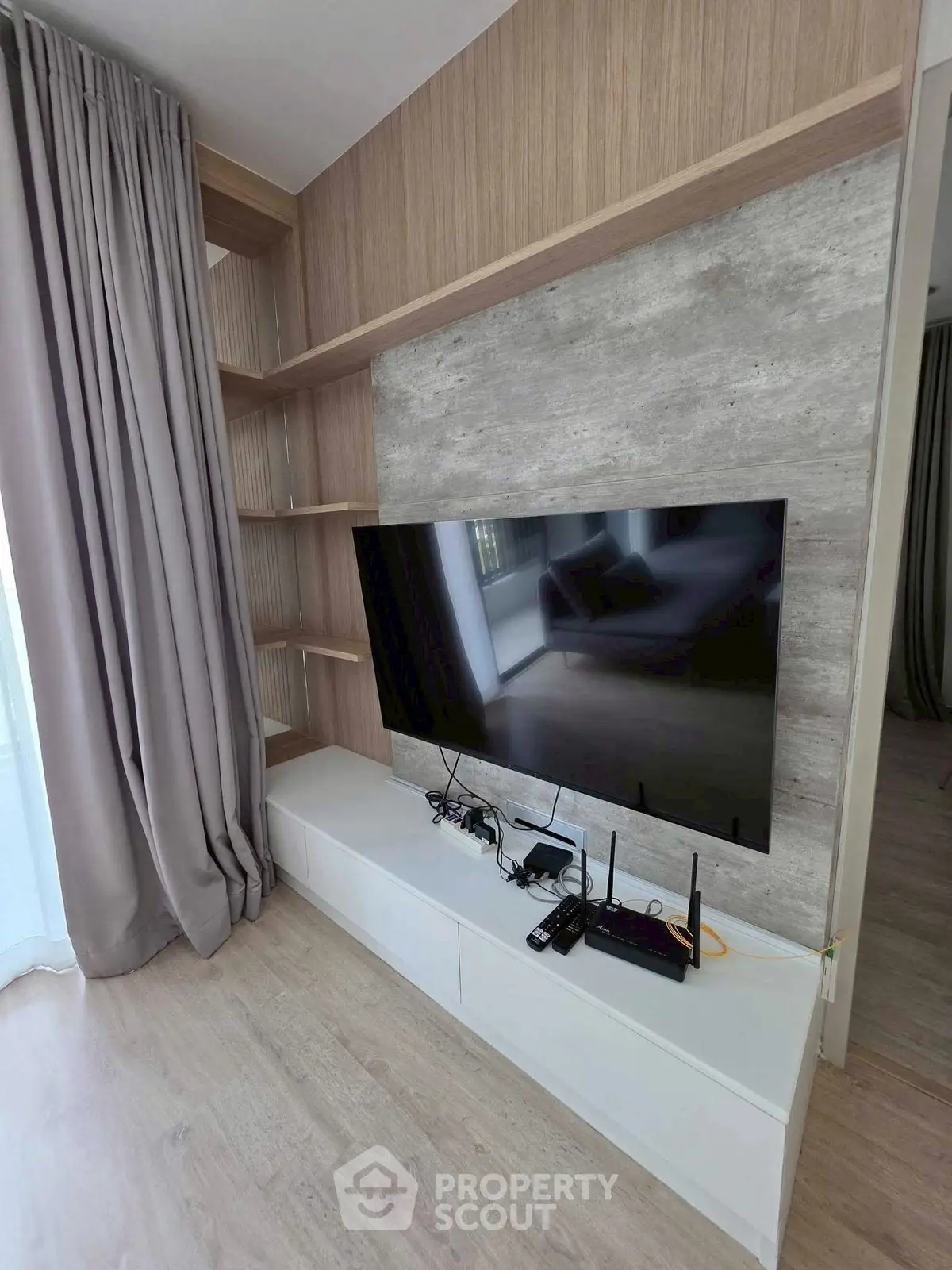 Modern living room with sleek TV setup and stylish shelving