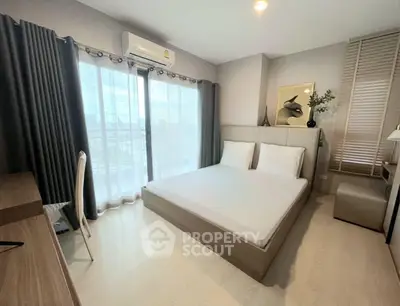 Modern bedroom with large window and stylish decor in a high-rise apartment.