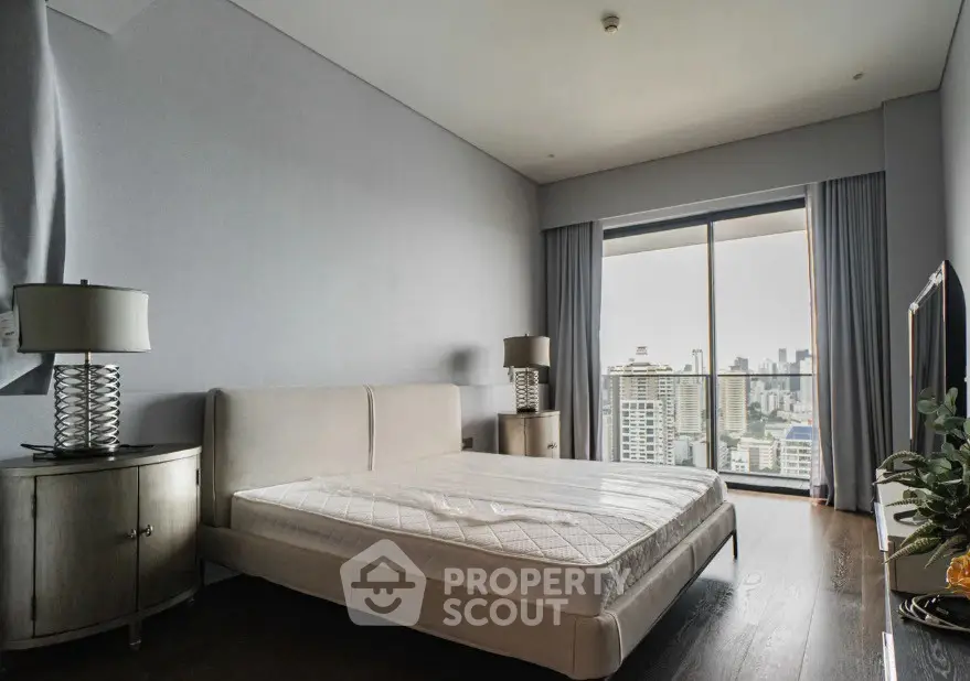 Spacious bedroom with city view and modern furnishings in luxury apartment