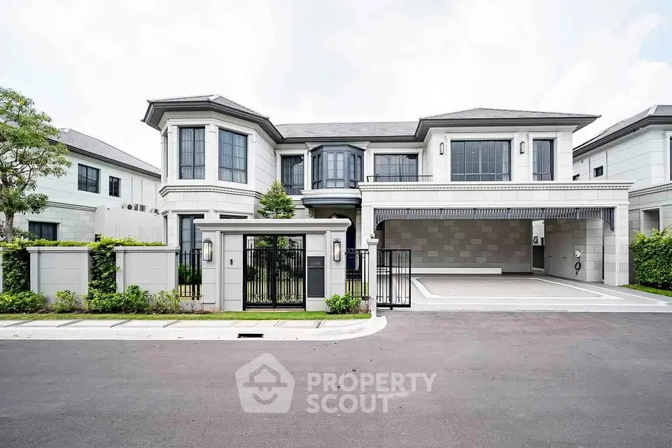 Luxurious modern mansion with spacious driveway and elegant facade in upscale neighborhood.