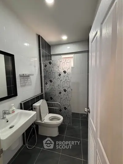 Modern bathroom with elegant tile design and sleek fixtures