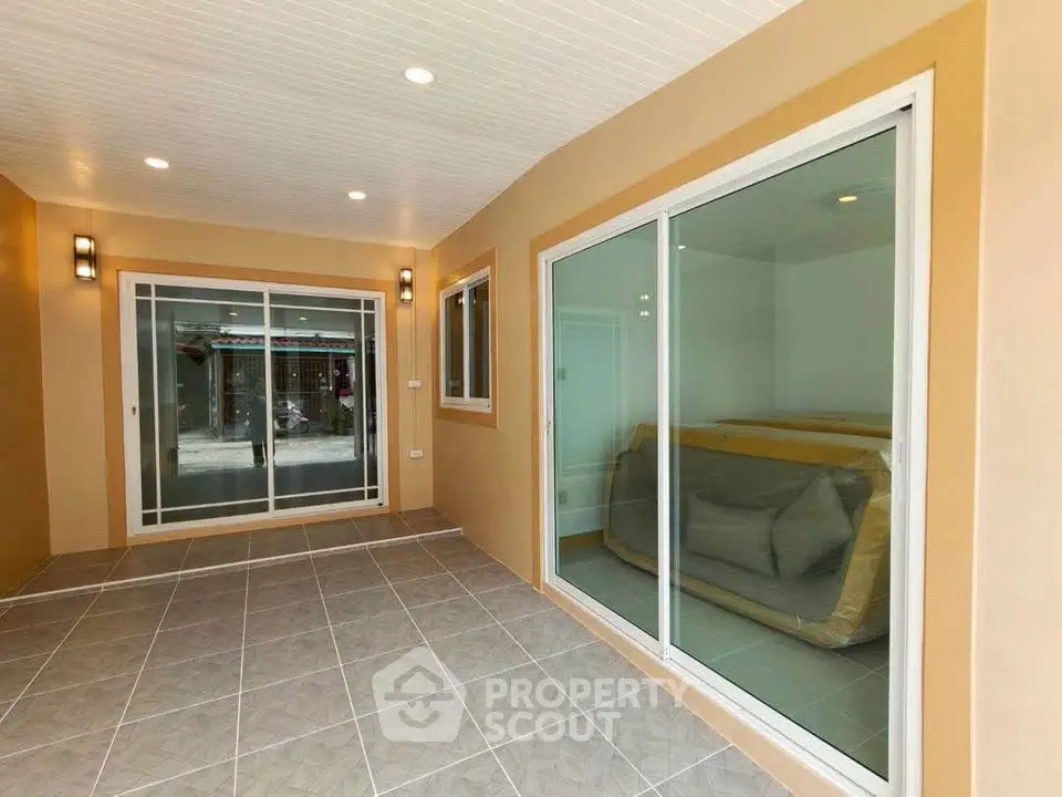 Spacious enclosed patio with sliding glass doors and modern lighting
