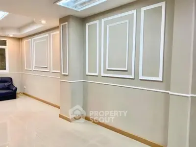 Elegant living room with modern wall paneling and recessed lighting