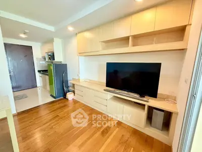 Modern living room with wooden flooring and built-in entertainment unit