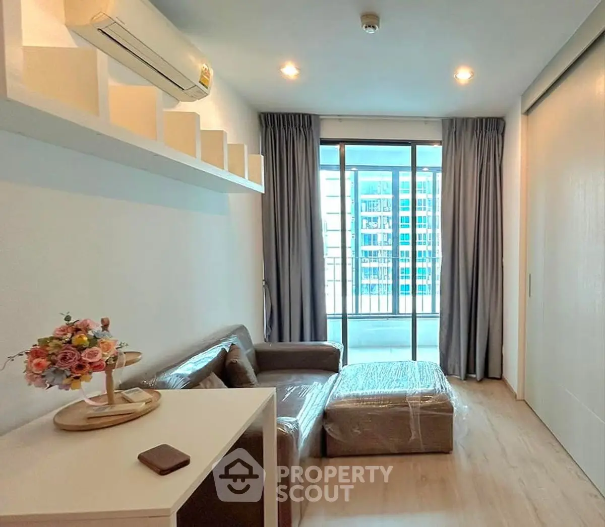 Modern living room with balcony view in urban apartment