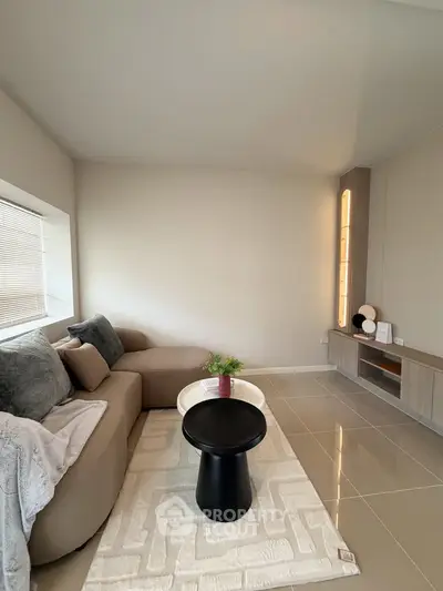 Modern living room with cozy sofa and sleek decor in a stylish apartment.