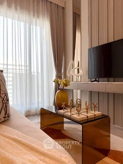 Elegant living room with modern decor, large TV, and floor-to-ceiling windows for natural light.