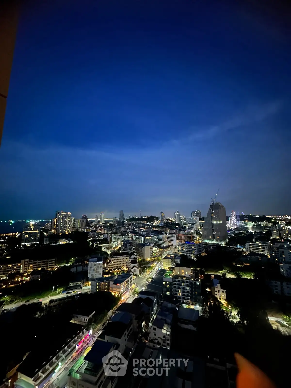 Stunning cityscape view from high-rise building at night, showcasing vibrant city lights and skyline.