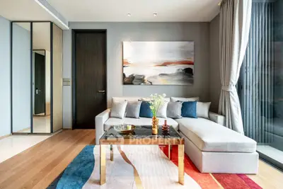 Modern living room with stylish decor, large windows, and cozy seating area.