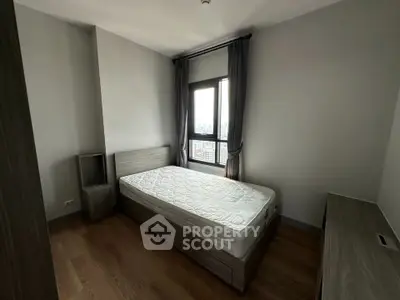 Modern minimalist bedroom with wooden flooring and large window view