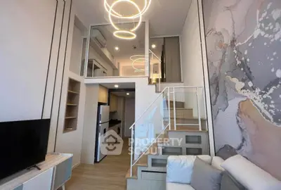 Modern loft apartment with stylish lighting and open layout, featuring a cozy living area and sleek kitchen.