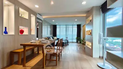 Spacious modern living room with dining area and large windows offering stunning views.