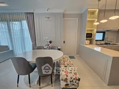 Elegant open-plan living and dining area with modern kitchen and stylish decor.