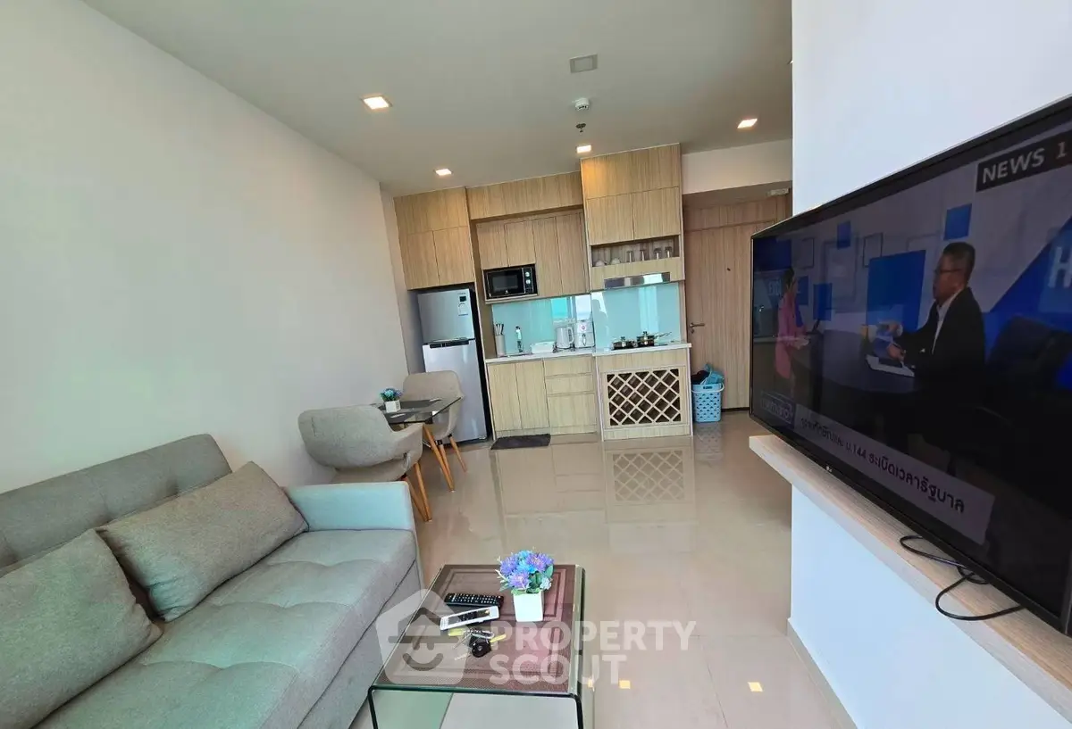Modern living room with open kitchen layout and stylish furniture