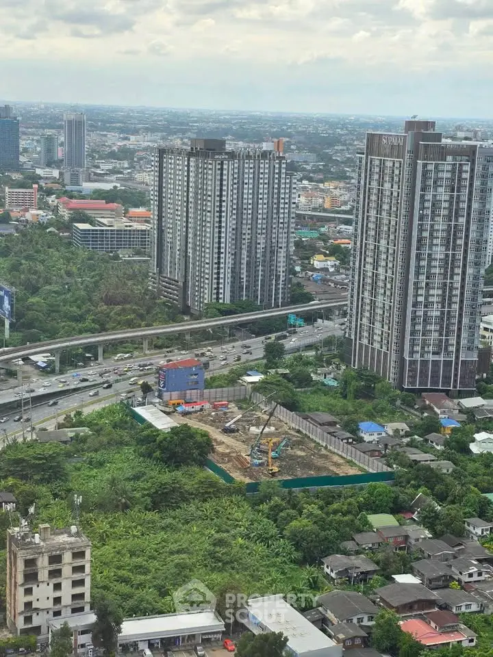Stunning aerial view of urban high-rise buildings and lush greenery, showcasing prime real estate development.