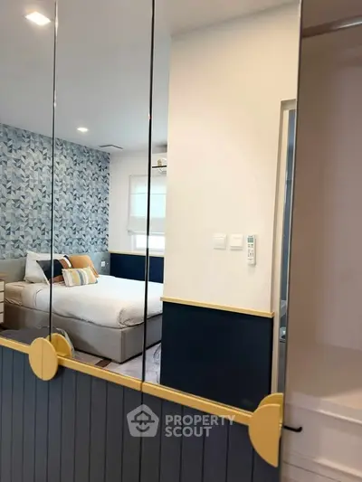 Modern bedroom with stylish decor and mirrored closet doors