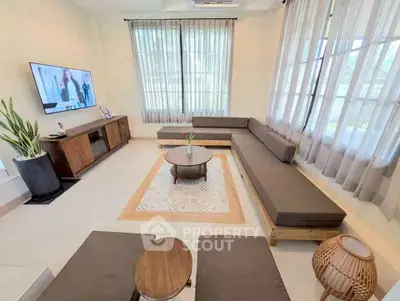 Spacious living room with modern furniture and large windows for natural light.