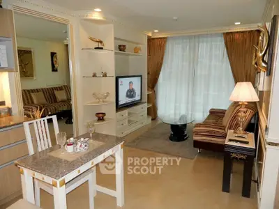 Elegant living room with stylish decor and natural light, featuring a cozy seating area and modern entertainment setup.