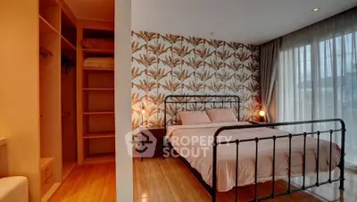 Charming bedroom with stylish wallpaper and cozy lighting in modern apartment.