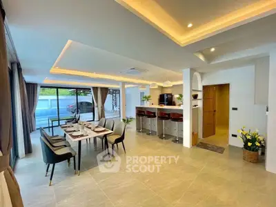 Spacious modern dining and living area with elegant decor and ample natural light.