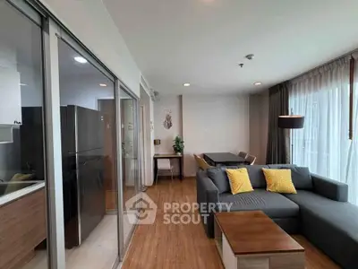 Modern living room with stylish decor and open layout, featuring a cozy sofa and dining area.