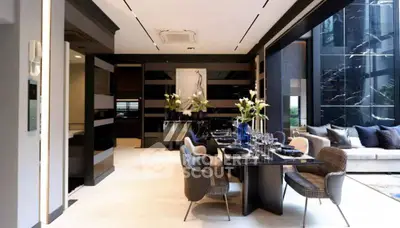 Luxurious open-plan dining and living area with elegant decor and modern furnishings.