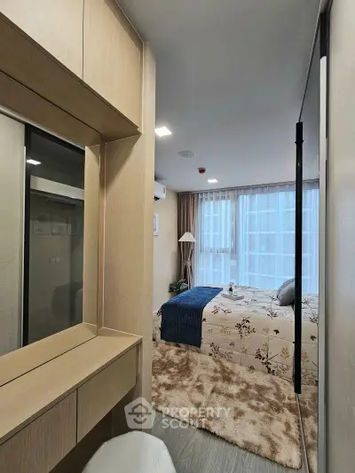 Cozy bedroom with modern decor and large window for natural light