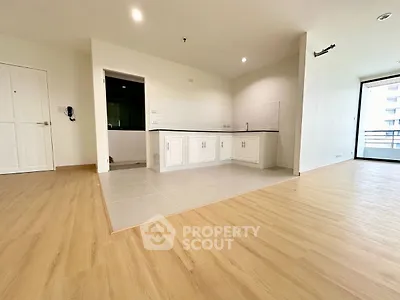 Spacious open-plan living area with modern kitchen and wooden flooring