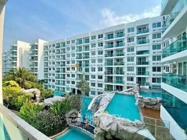 Luxurious condominium with stunning pool and lush greenery, perfect for modern living.