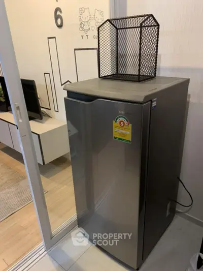 Modern apartment interior with compact refrigerator and stylish decor