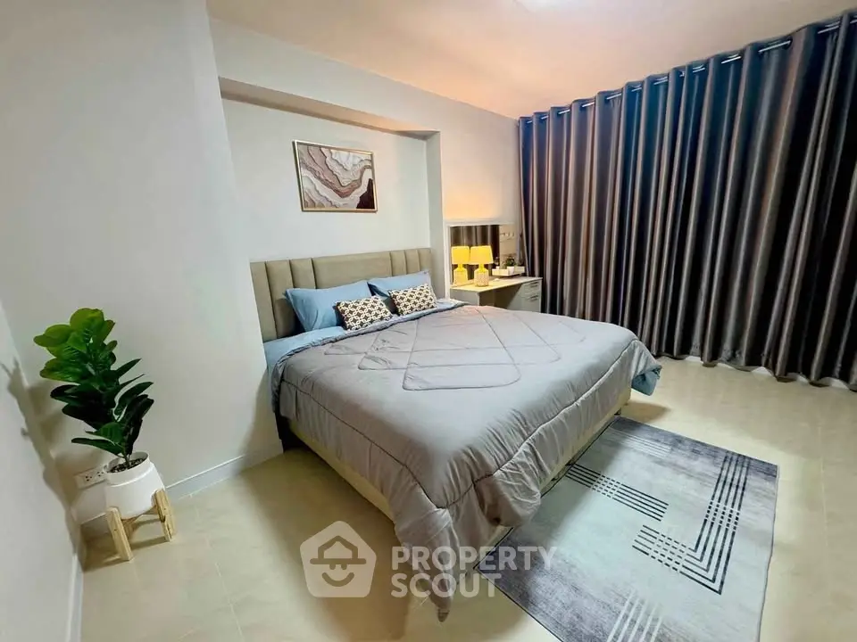 Modern bedroom with stylish decor and cozy ambiance, featuring a plush bed and elegant curtains.