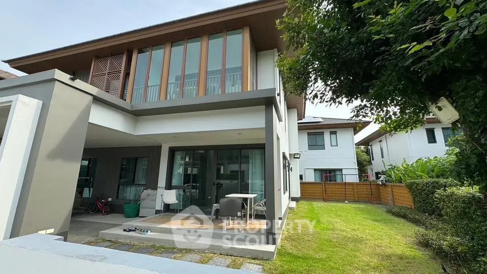Modern two-story house with spacious garden and patio area