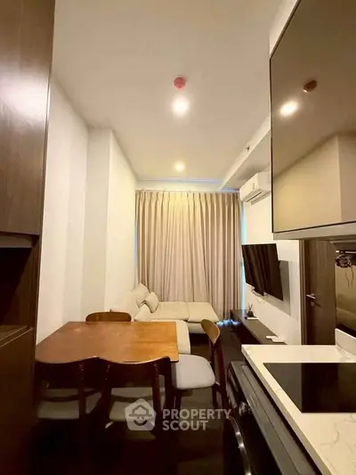 Cozy modern living room with stylish furniture and open kitchen layout