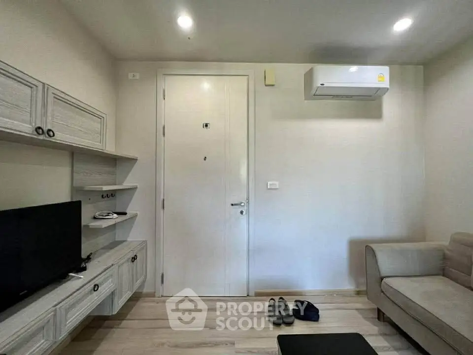 Modern living room with sleek furniture and air conditioning unit, perfect for cozy living.