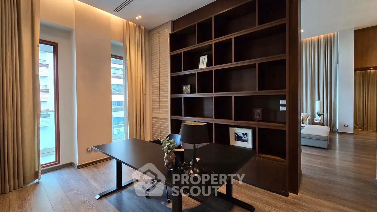 Luxurious study room with elegant wooden shelving and modern desk in a high-end apartment.