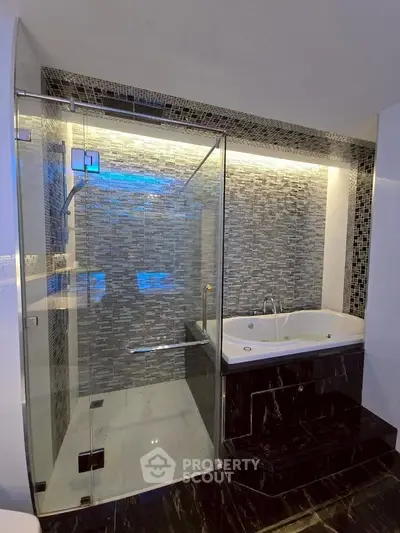 Luxurious bathroom with modern glass shower and elegant bathtub