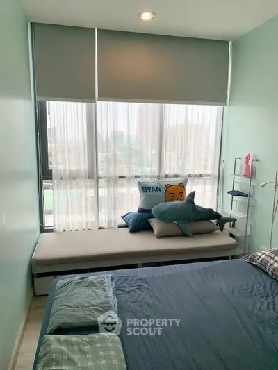 Cozy bedroom with large window and stylish decor in modern apartment