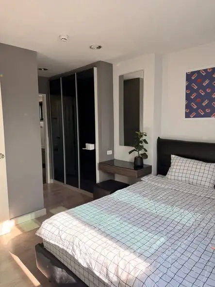 Modern bedroom with stylish decor and ample natural light