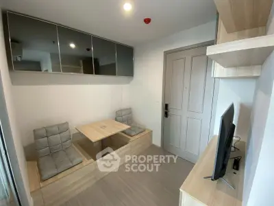 Modern compact living room with built-in seating and wall-mounted TV in a stylish apartment.