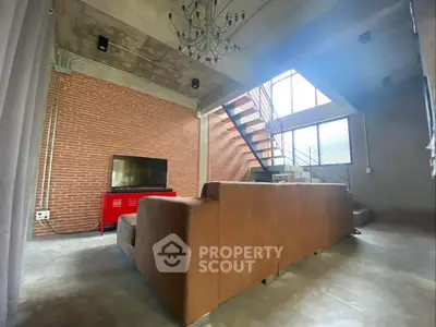 Modern industrial loft with exposed brick and high ceilings