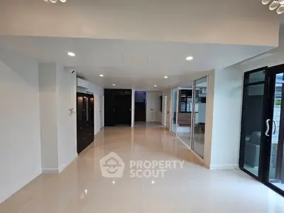 Spacious modern living room with sleek tile flooring and large windows
