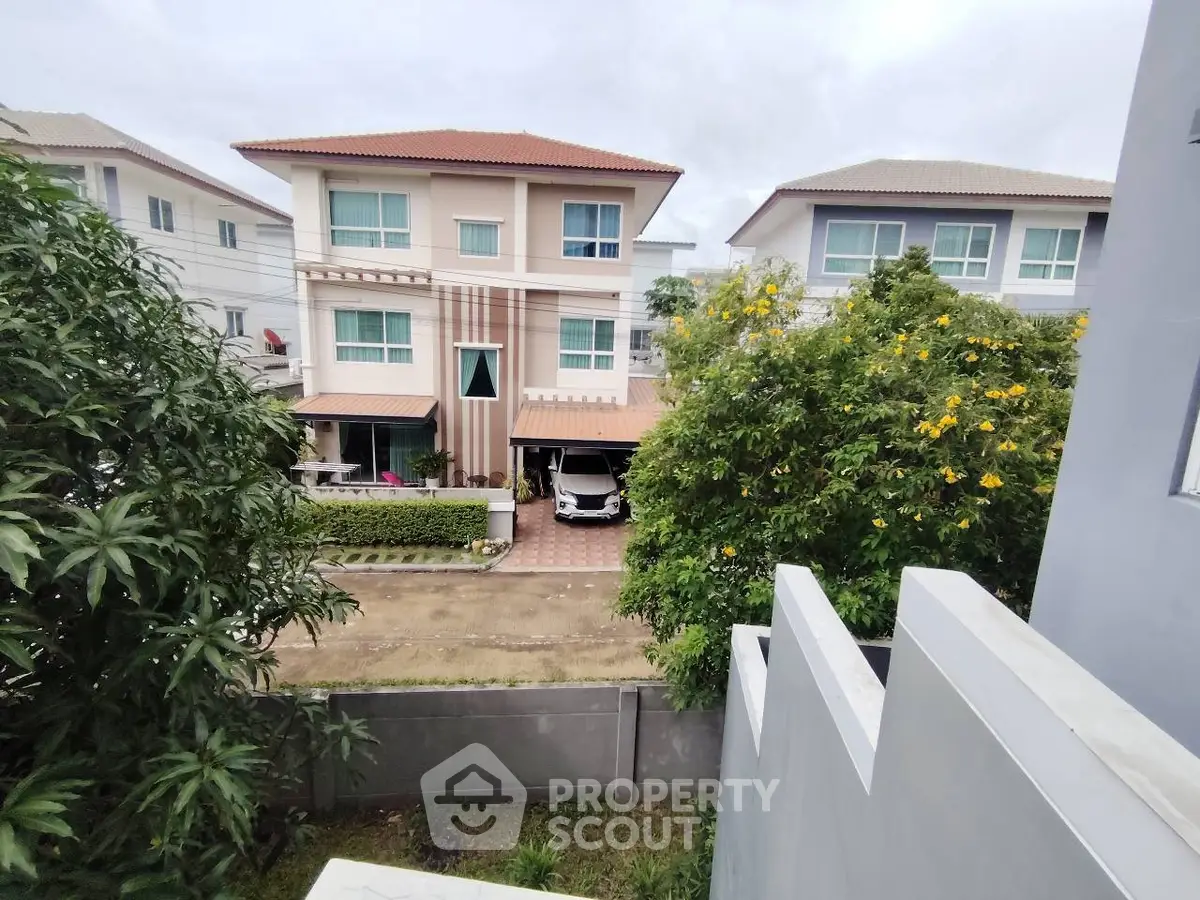 Charming suburban homes with lush greenery and spacious driveways in a peaceful neighborhood.
