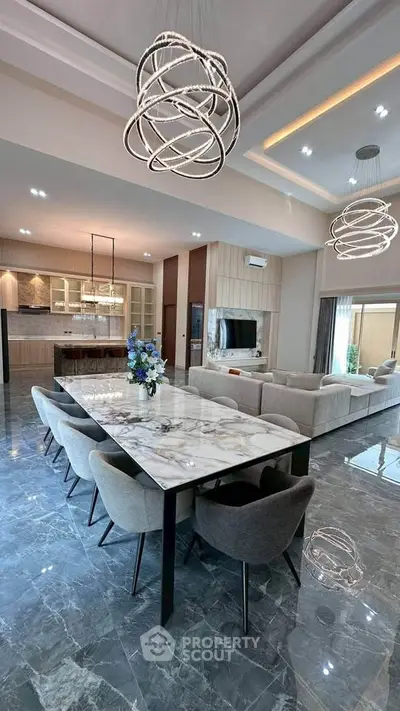 Luxurious open-plan living and dining area with modern lighting and marble flooring