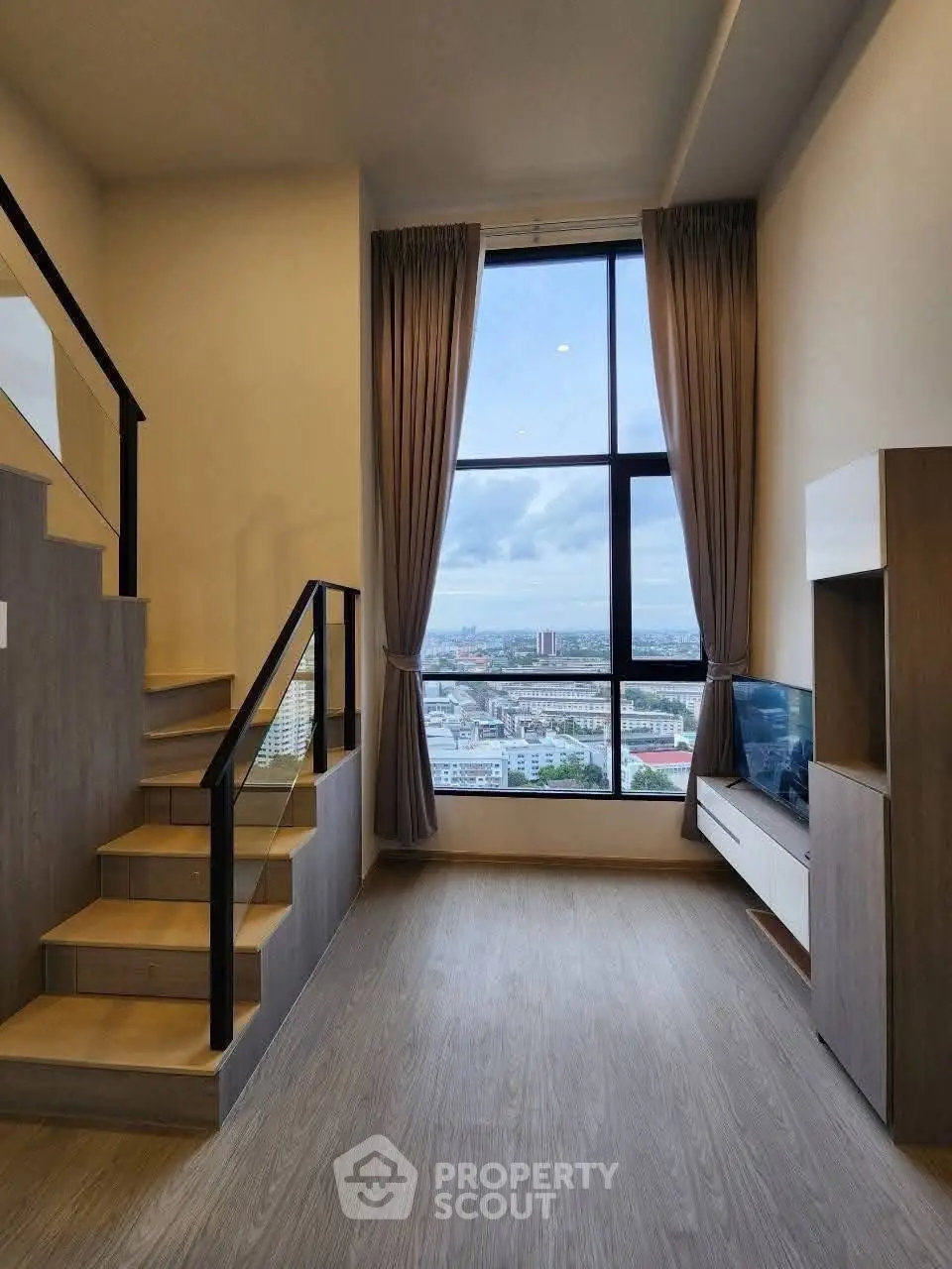 Modern duplex living room with large window and city view